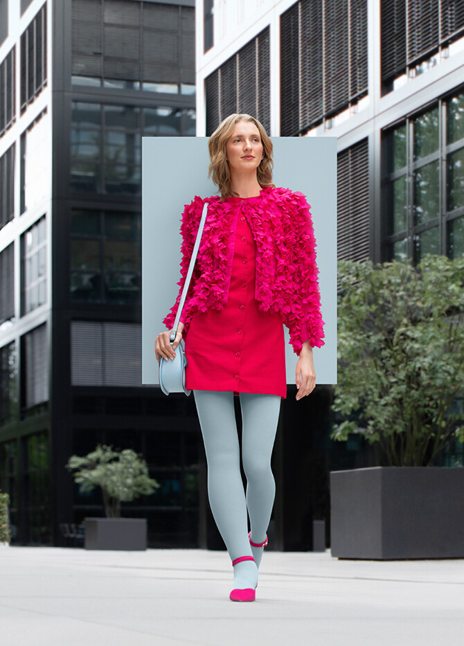 Icy Blue A woman with lymphoedema walks through the city wearing an Icy Blue compression garment with a pink dress
