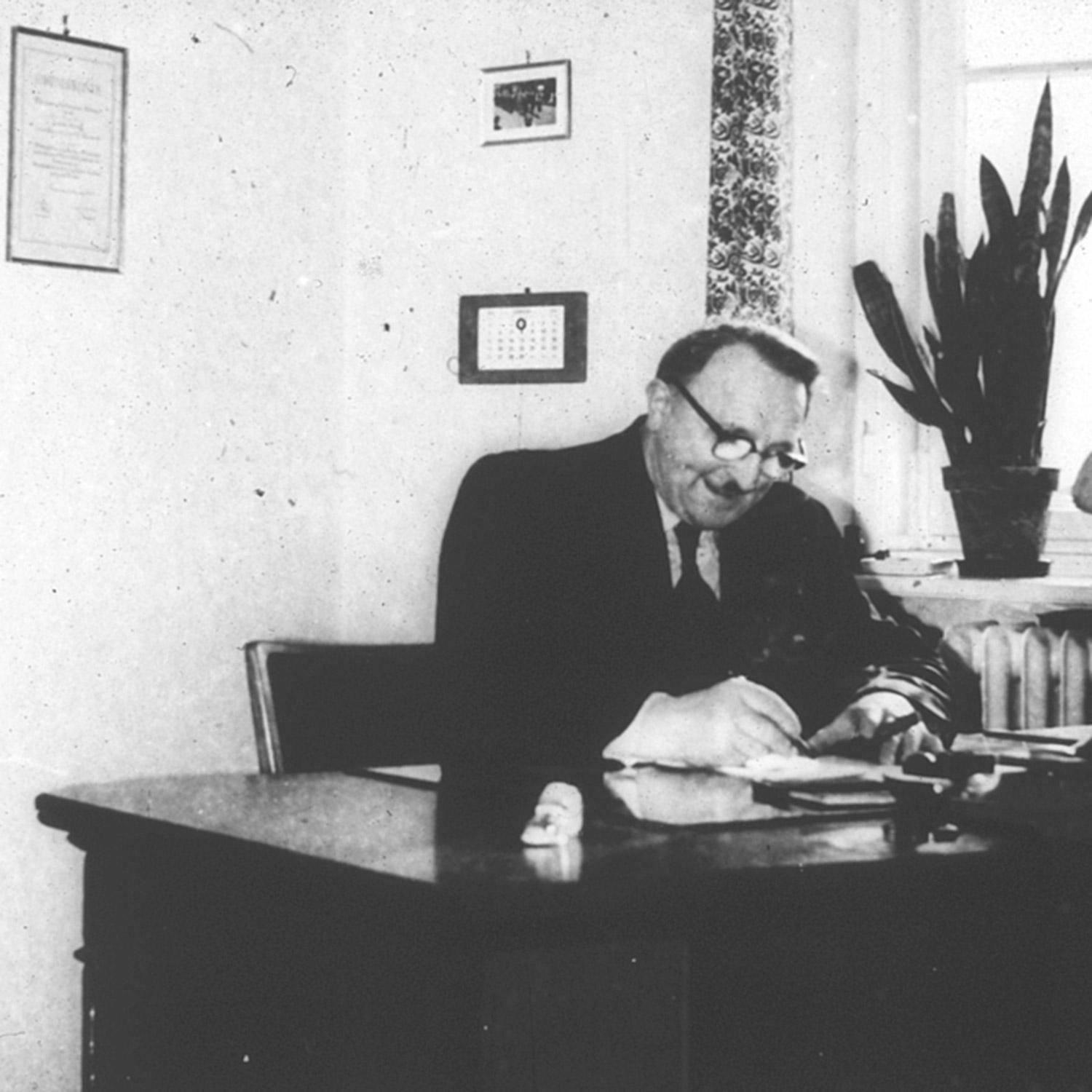 1962 Man sitting at a desk 1962 Man sitting at a desk