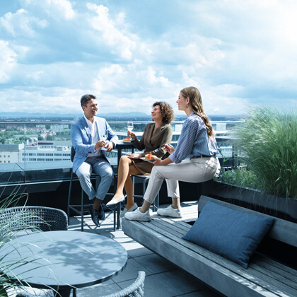 Phlebology A man and two women are on a rooftop terrace wearing compression stockings.A man and two women are on a rooftop terrace wearing compression stockings.