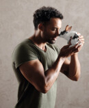 Strong man has a bunny on his hand
