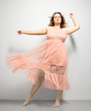 1. Lifestyle image Juzo Inspiration Woman with Juzo Inspiration and tights in almond and pink dress
